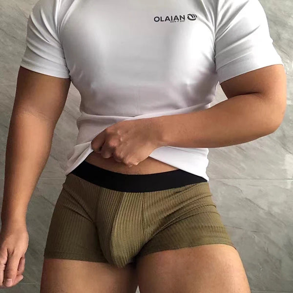 Cropped model wearing olive ribbed cotton boxers with a black waistband