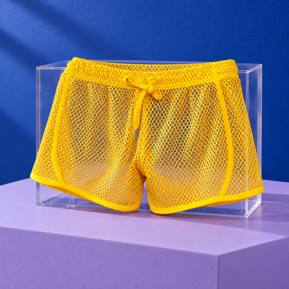 Yellow loose mesh boxer shorts with matching drawstring and bound hems displayed on clear acrylic.