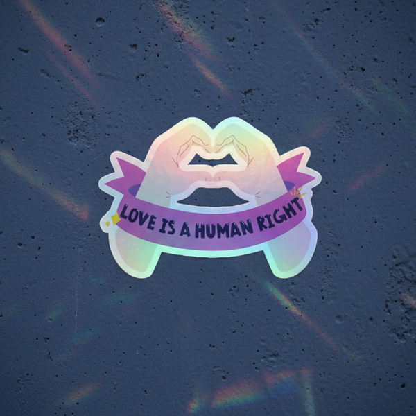 Holographic “Love Is A Human Right” sticker with pastel rainbow-outlined kissing lips, purple banner