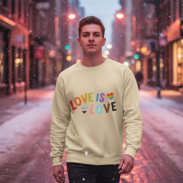 Model wearing a cream sweatshirt reading “LOVE IS LOVE” with rainbow and pride-flag hearts