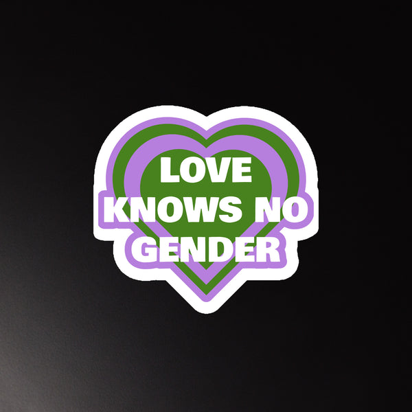 Heart-shaped magnet reading “LOVE KNOWS NO GENDER” in white, purple, and green