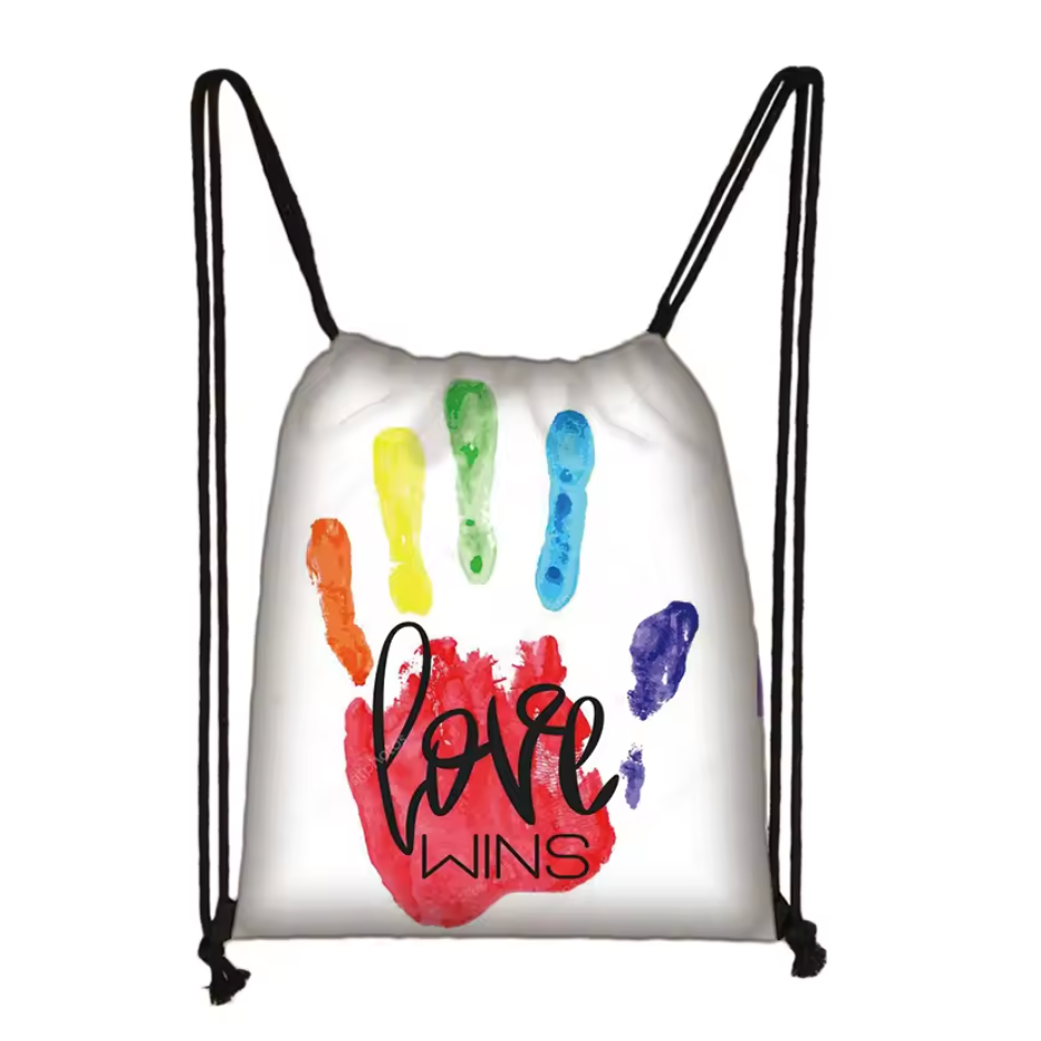 Close-up of a white drawstring bag with colorful brushstrokes and “Love Wins” lettering