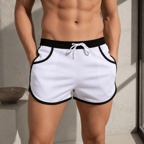 Front view of a model wearing white shorts with black trim and a drawstring