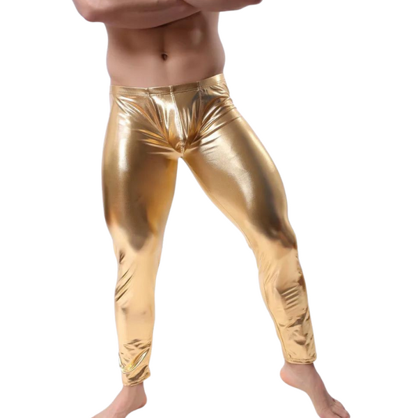 Front view of a shirtless model wearing shiny gold low-waist leggings