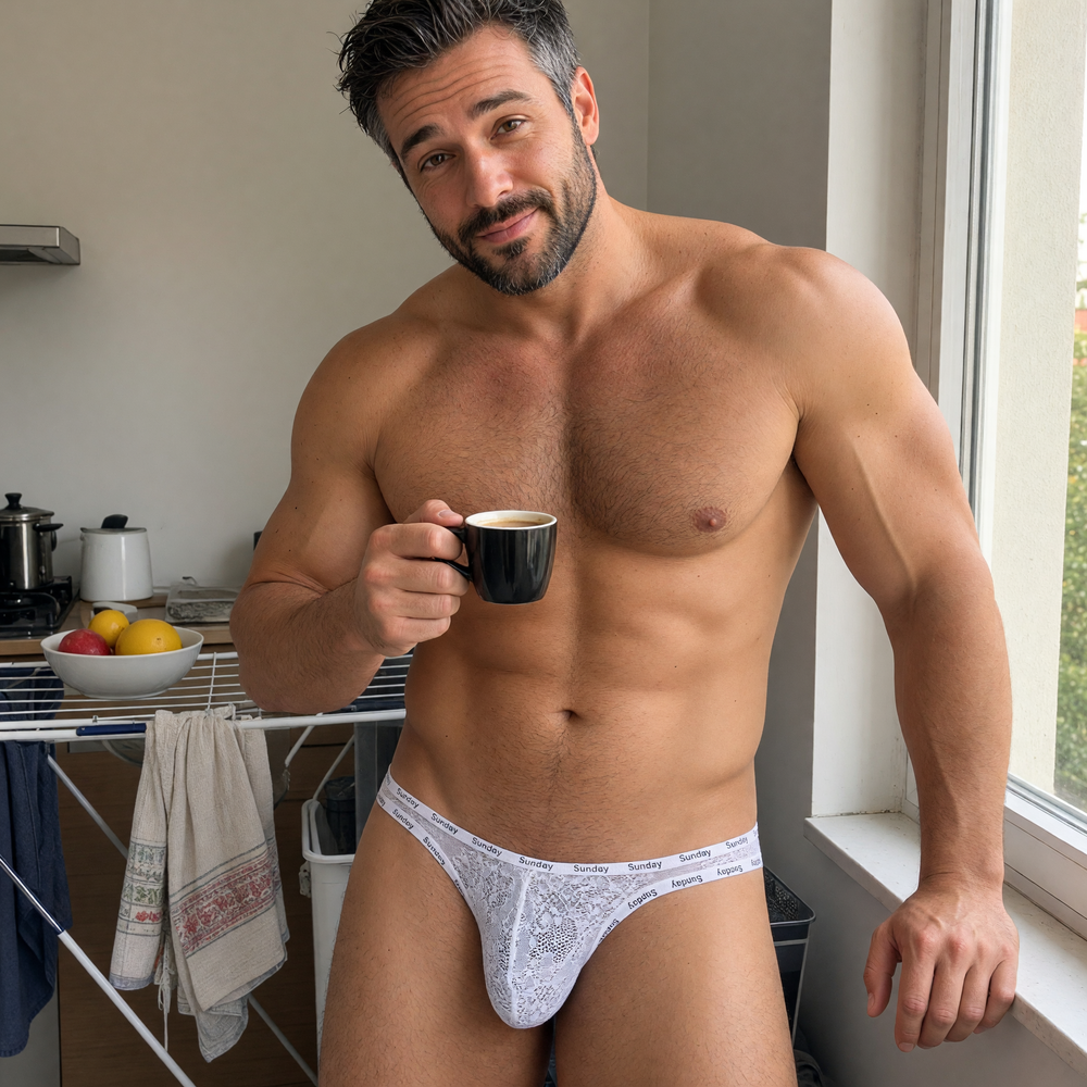 Man wearing white lace briefs with Sunday-print trim while holding a mug