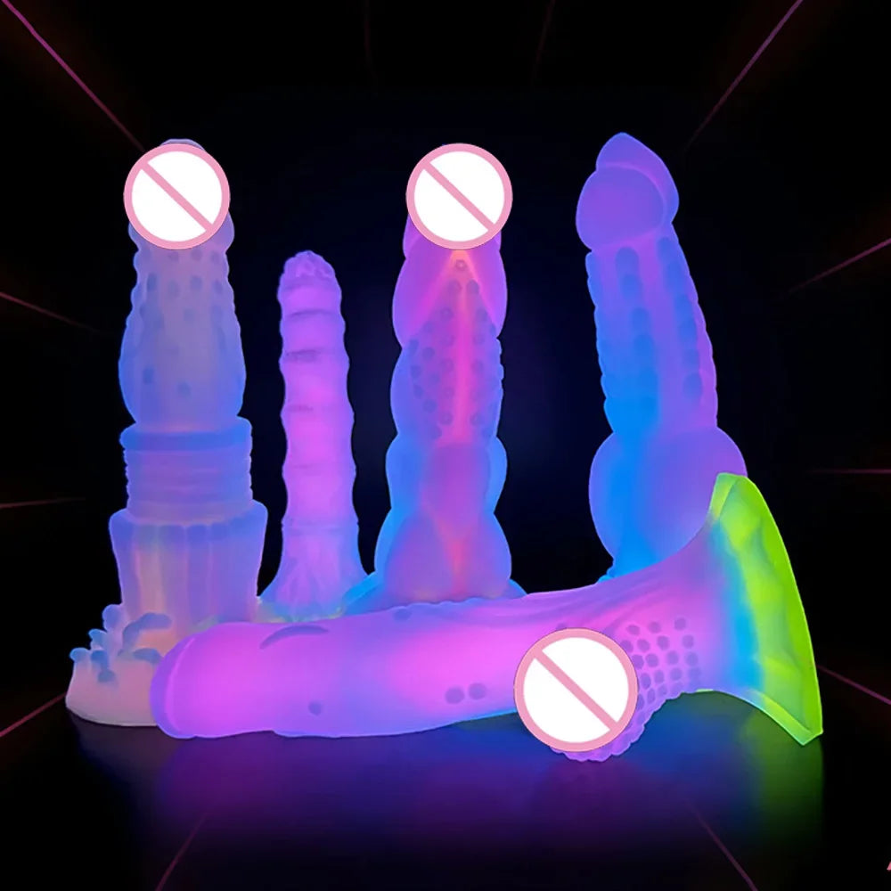 Neon-lit arrangement of five colorful textured silicone dildos on a black surface