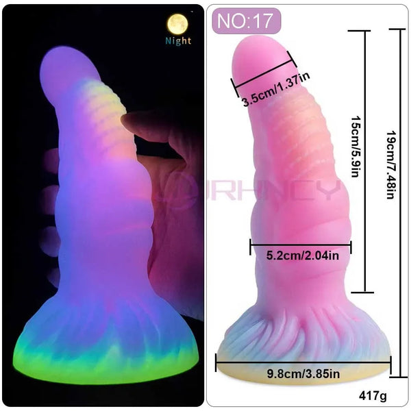 Glow-in-the-dark pink fantasy dildo shown lit and with measurements