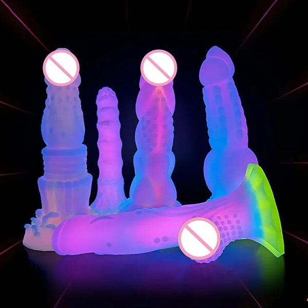 Neon-lit arrangement of five colorful textured silicone dildos on a black surface
