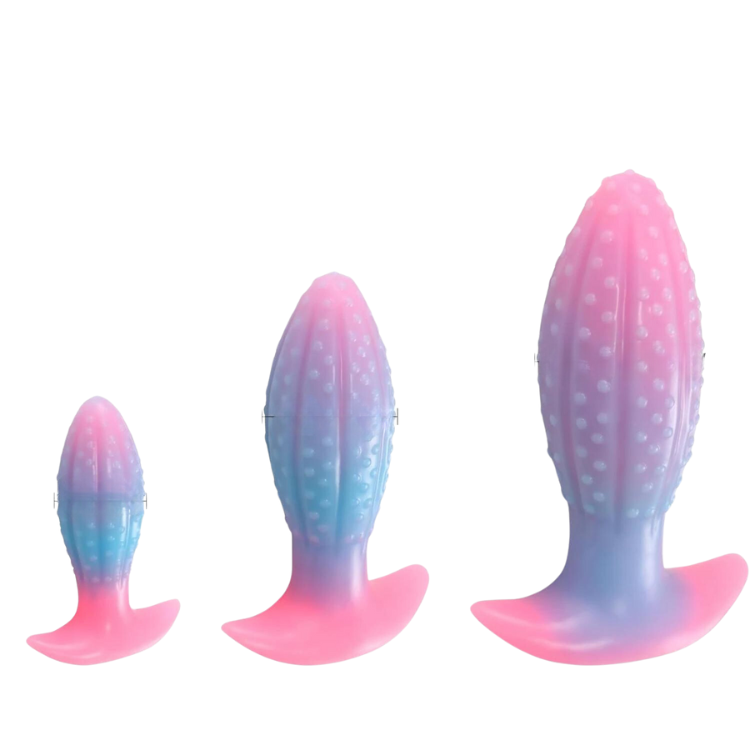 Three pink-and-blue textured butt plugs shown upright in graduated sizes