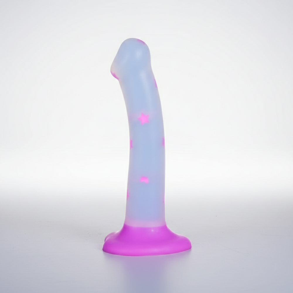 Glow-in-the-dark dildo with pink stars and a wide suction-cup base