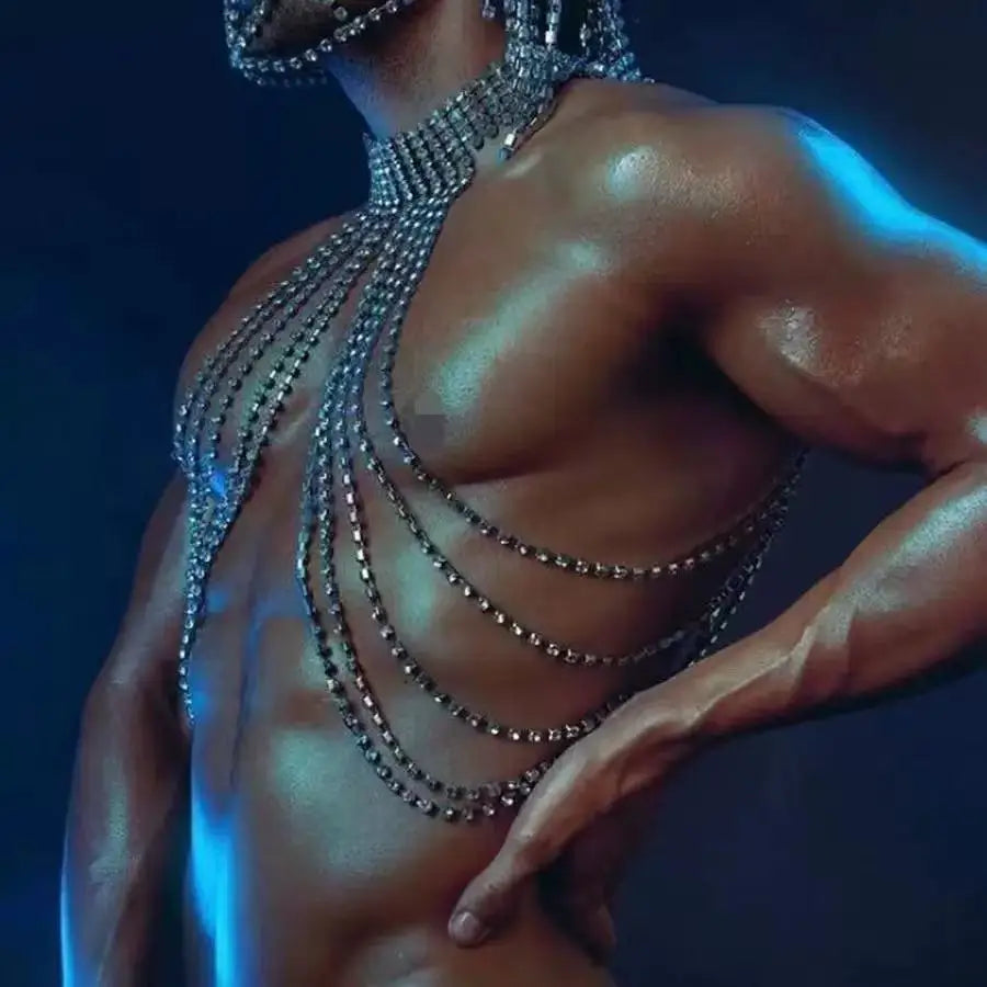 Close-up of a shirtless model wearing layered silver chain chest jewelry
