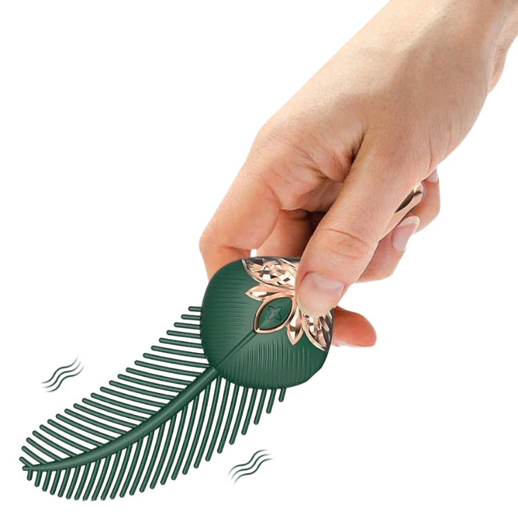 Hand holding a green feather-shaped clitoral wand with rose-gold floral detailing