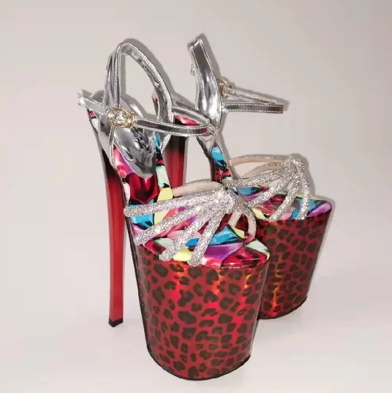 Pair of towering platform heels with red leopard-print soles and silver glitter straps