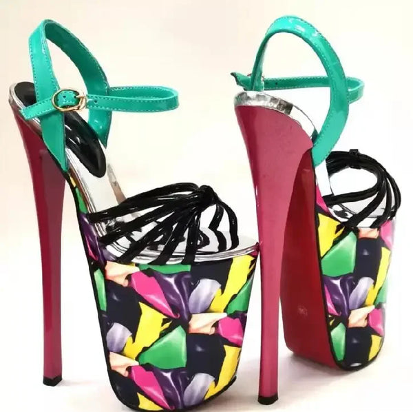 Pair of towering platform heels with turquoise ankle straps and colorful abstract-print uppers