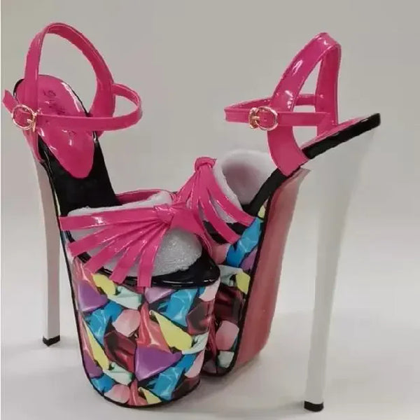 Pair of pink platform heels with ankle straps and colorful abstract-print uppers