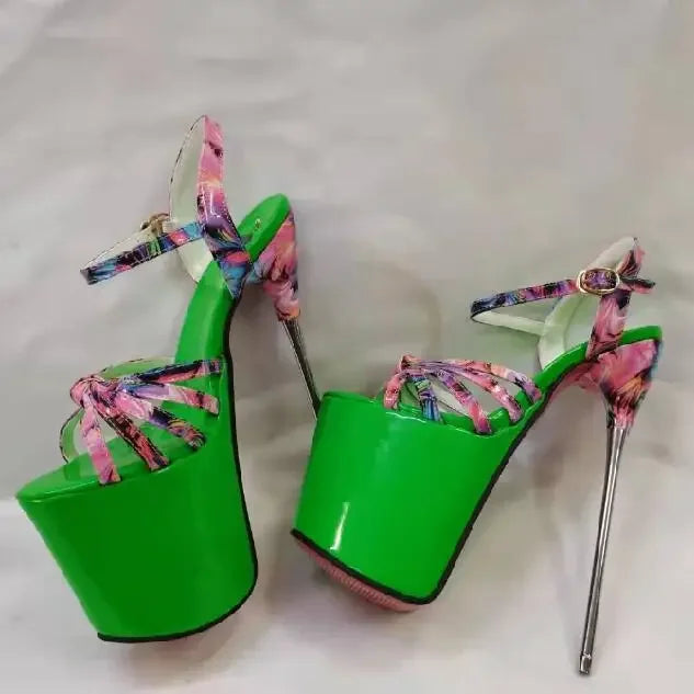 Pair of neon-green platform heels with pink patterned ankle straps and stilettos