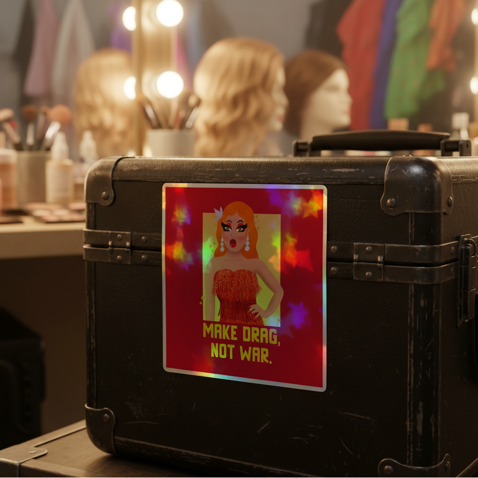 Make Drag Not War holographic sticker on a makeup case, featuring a drag queen in a red dress and rainbow hues; wigs, makeup