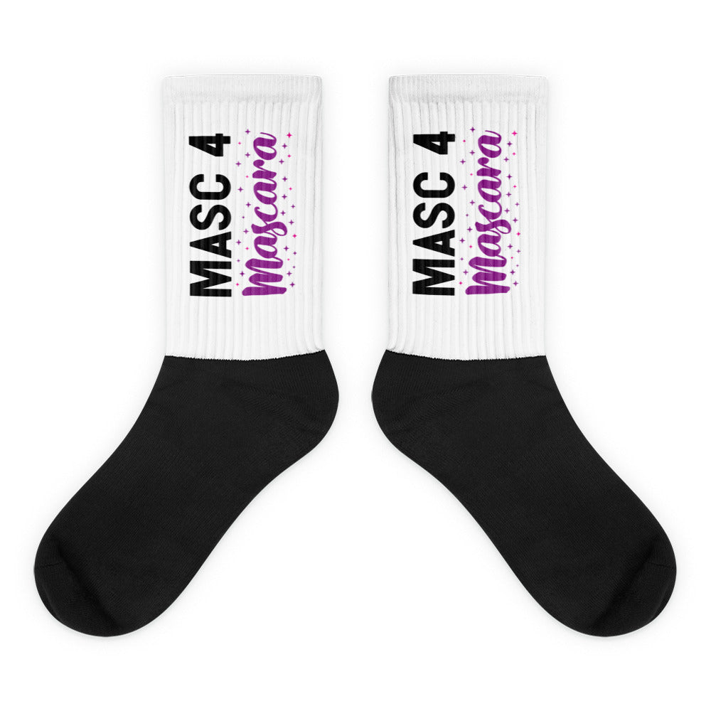 Pair of black-and-white crew socks with “MASC 4 Mascara” lettering and stars