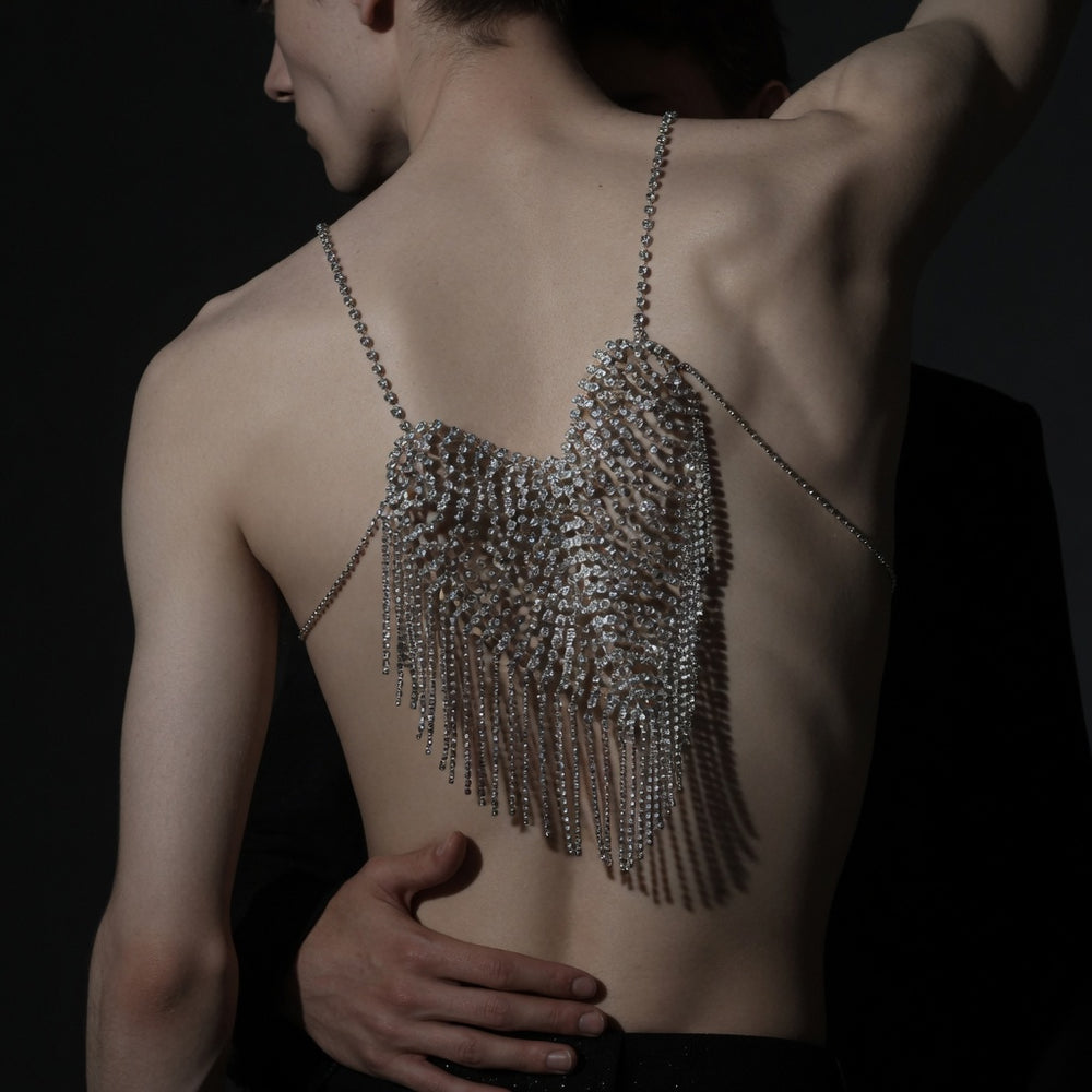 Back view of a model wearing a rhinestone halter chain top with long fringe