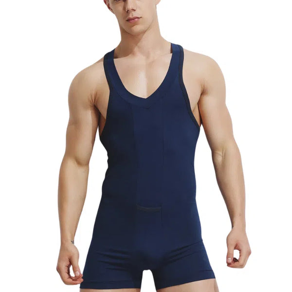 Front-view model wearing a navy V-neck tank bodysuit with fitted shorts