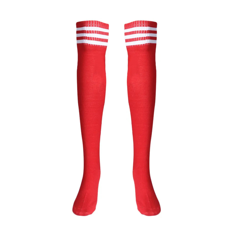 Pair of long red sports socks with three white stripes near the cuffs, shown upright on white