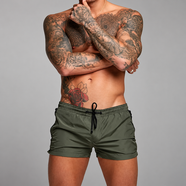 Front-view model wearing olive-green shorts with a black drawstring and zip pockets