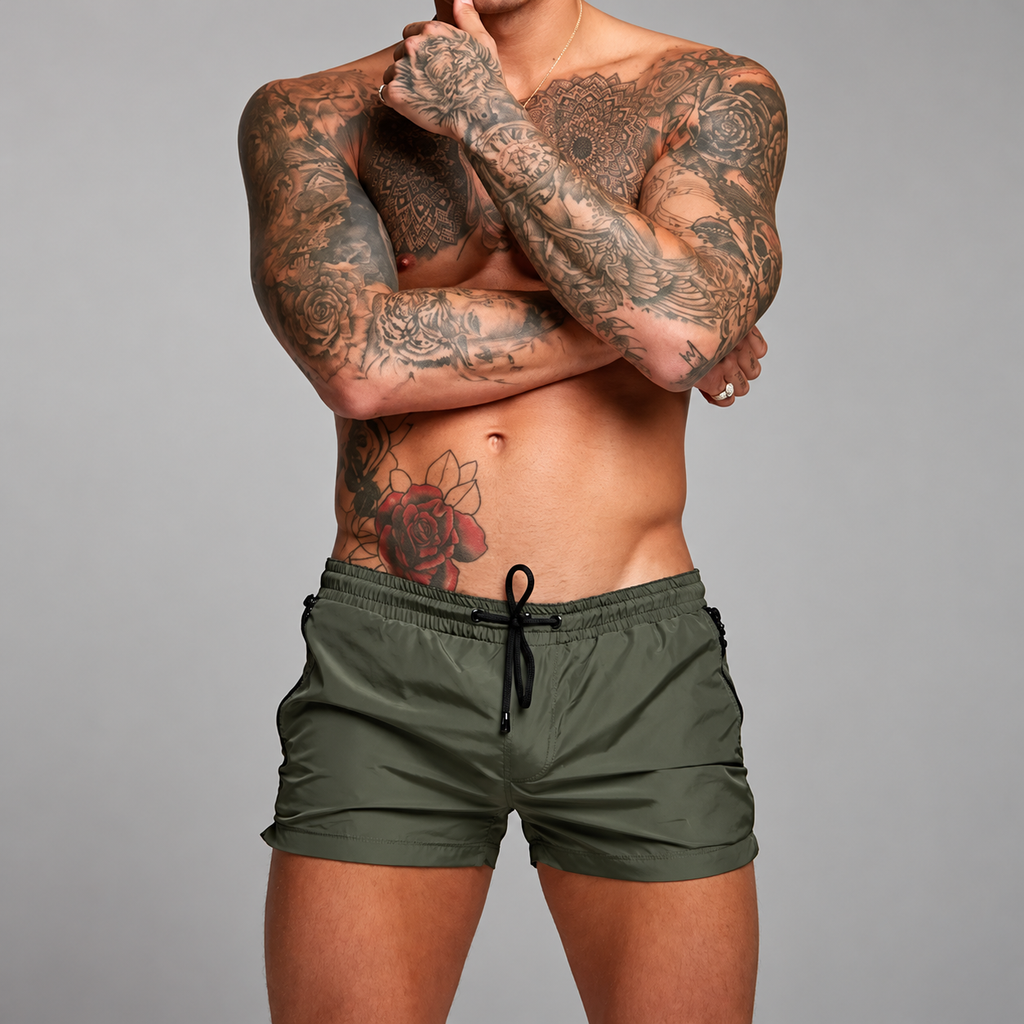Front-view model wearing olive-green shorts with a black drawstring and zip pockets