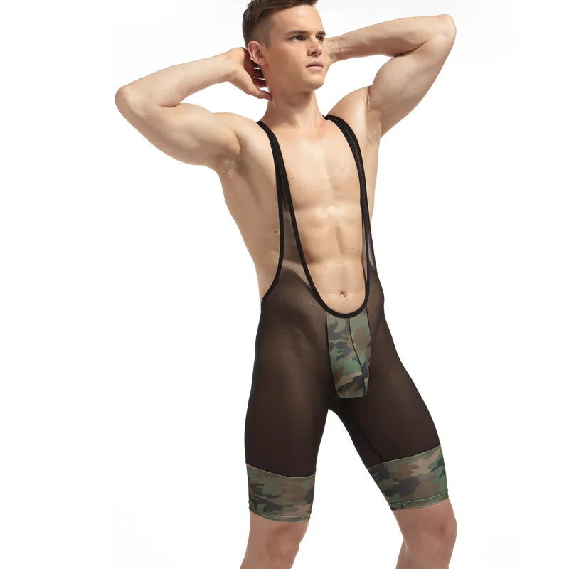 Front-view model wearing a sheer black mesh jumpsuit with camouflage panels