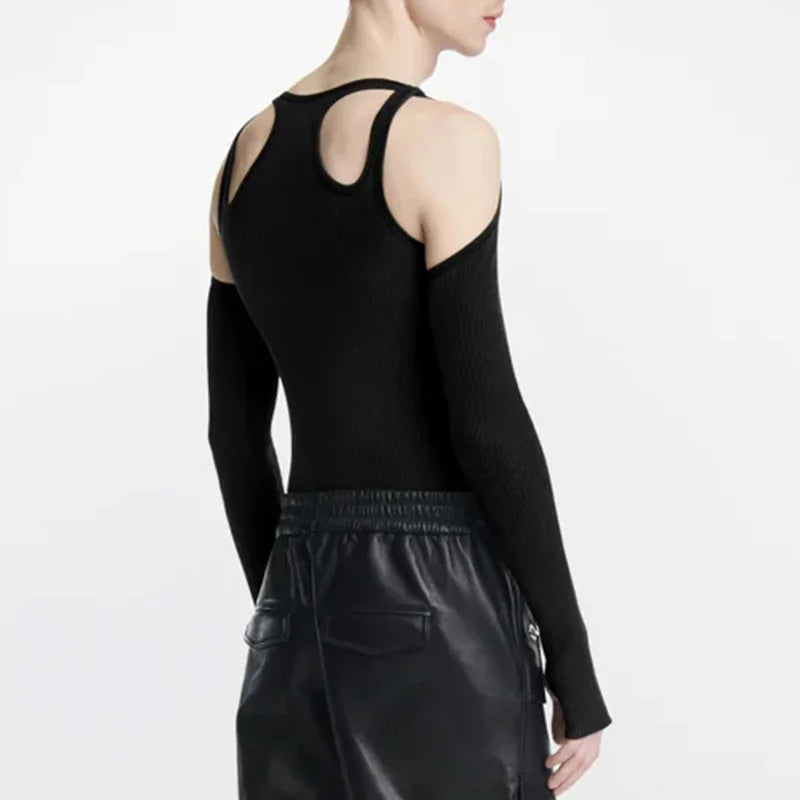 Back view of a model wearing a black cut-out top with exposed shoulders and upper back