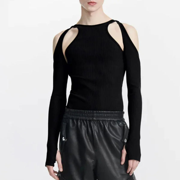 Front view of a model wearing a black long-sleeve top with shoulder cut-outs and black leather-look pants