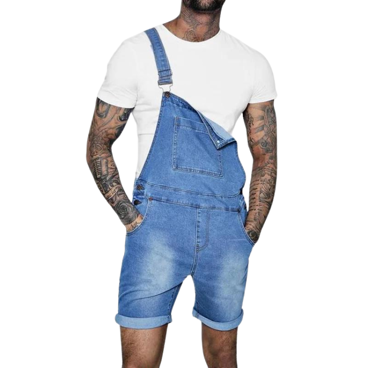 Front view of a tattooed person wearing blue denim bib shorts over a white T-shirt