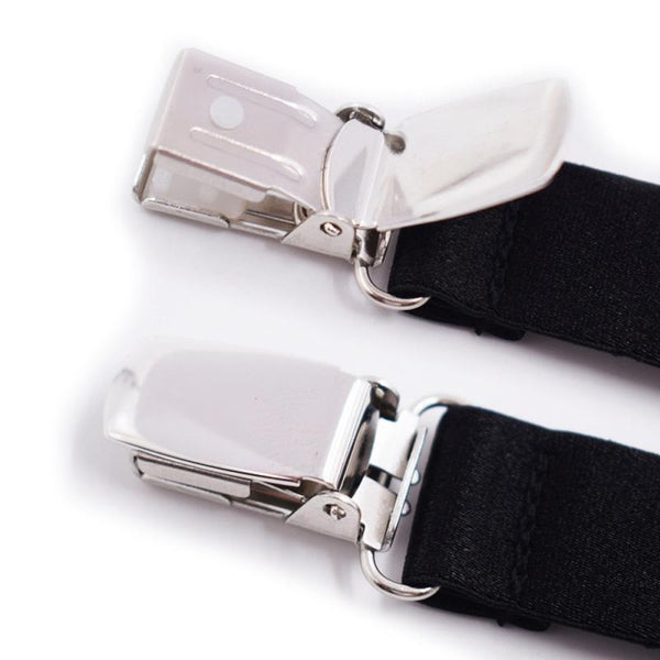Close-up of two black elastic garters with shiny silver clip fasteners