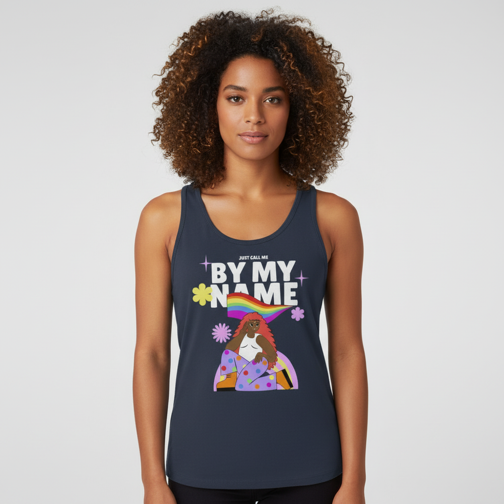 Navy-blue tank top featuring Just Call Me By My Name in white, with a vibrant illustration of a red-haired woman, rainbow, stars, and flowers, celebrating queer pride and self-expression.