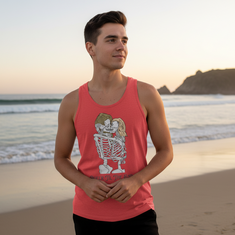 Queer Til The End" Unisex Tank Top flaunts a cartoon skeleton couple; worn by a young man chilling beachside at sunset.