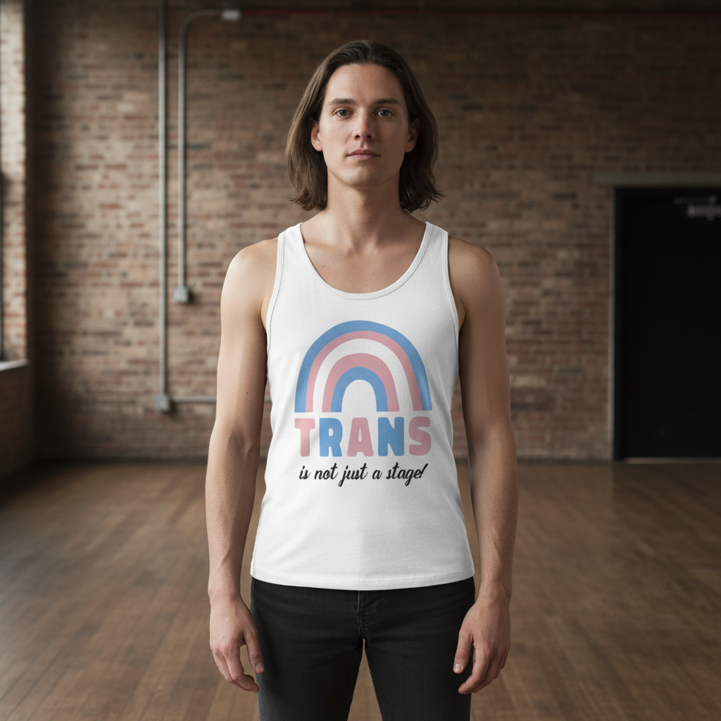 Trans Is Not Just A Stage! unisex tank top with bold text and a pastel rainbow, worn by a queer person on wooden floors indoors.