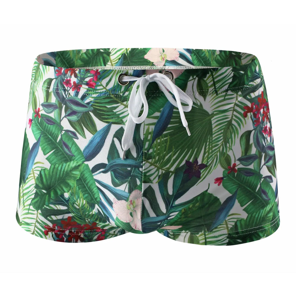 Front view of floral swim trunks with a white drawstring and tropical leaf print