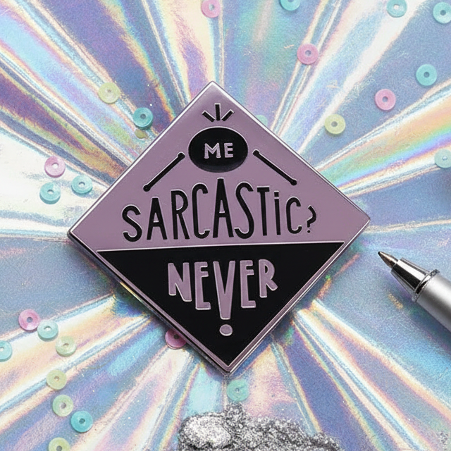 Enamel pin reading “ME SARCASTIC? NEVER!” on an iridescent background
