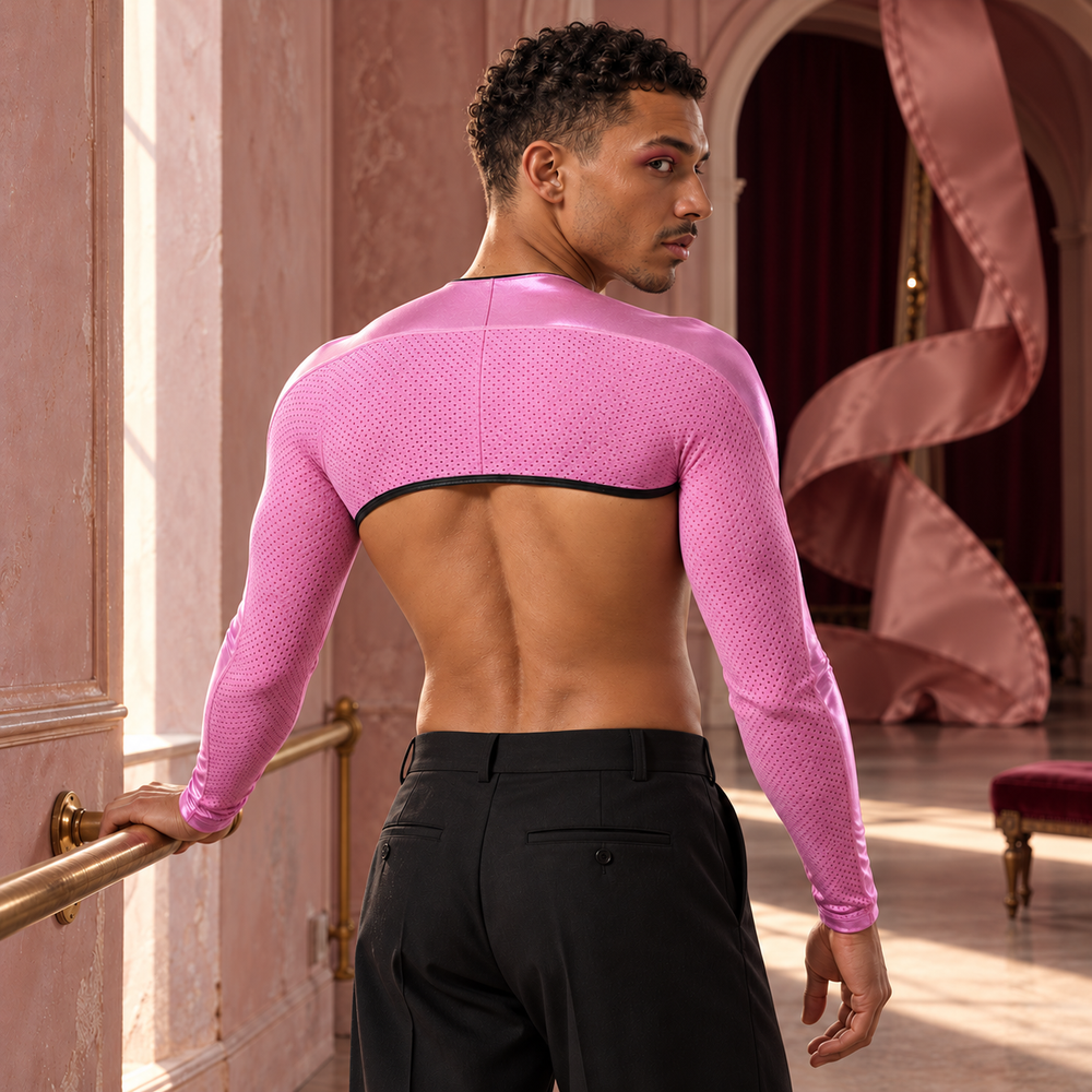 Adult model wearing the pink Mesh Mayhem shoulder-bolero, shown from behind in a sculptural pink theatre
