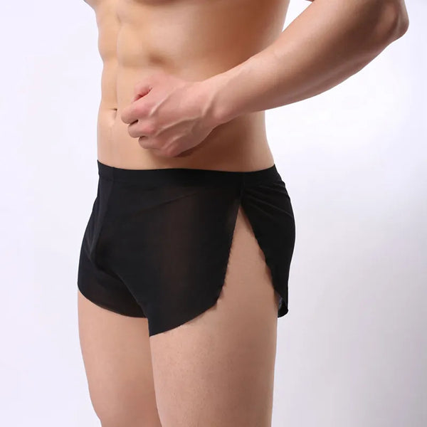 Cropped model wearing black sheer side-slit boxer briefs in a front three-quarter view