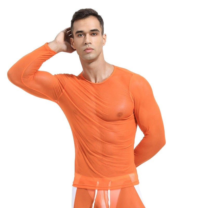 Front-facing model wearing a sheer orange long-sleeve mesh shirt and matching briefs