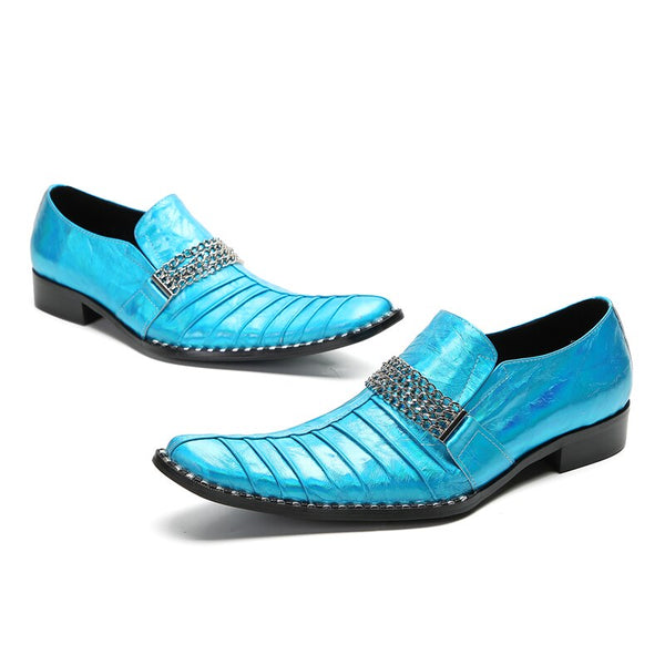 Pair of turquoise metallic pointed-toe dress shoes with chain straps on a white background