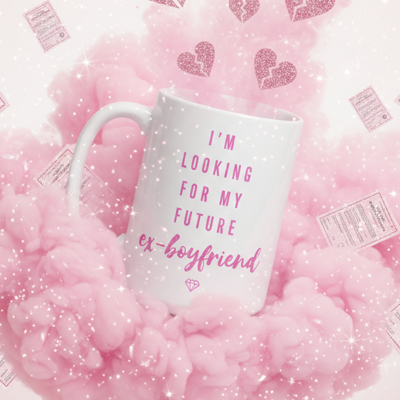 Pink-and-white mug reading “I’m looking for my future ex-boyfriend” among pink clouds and hearts