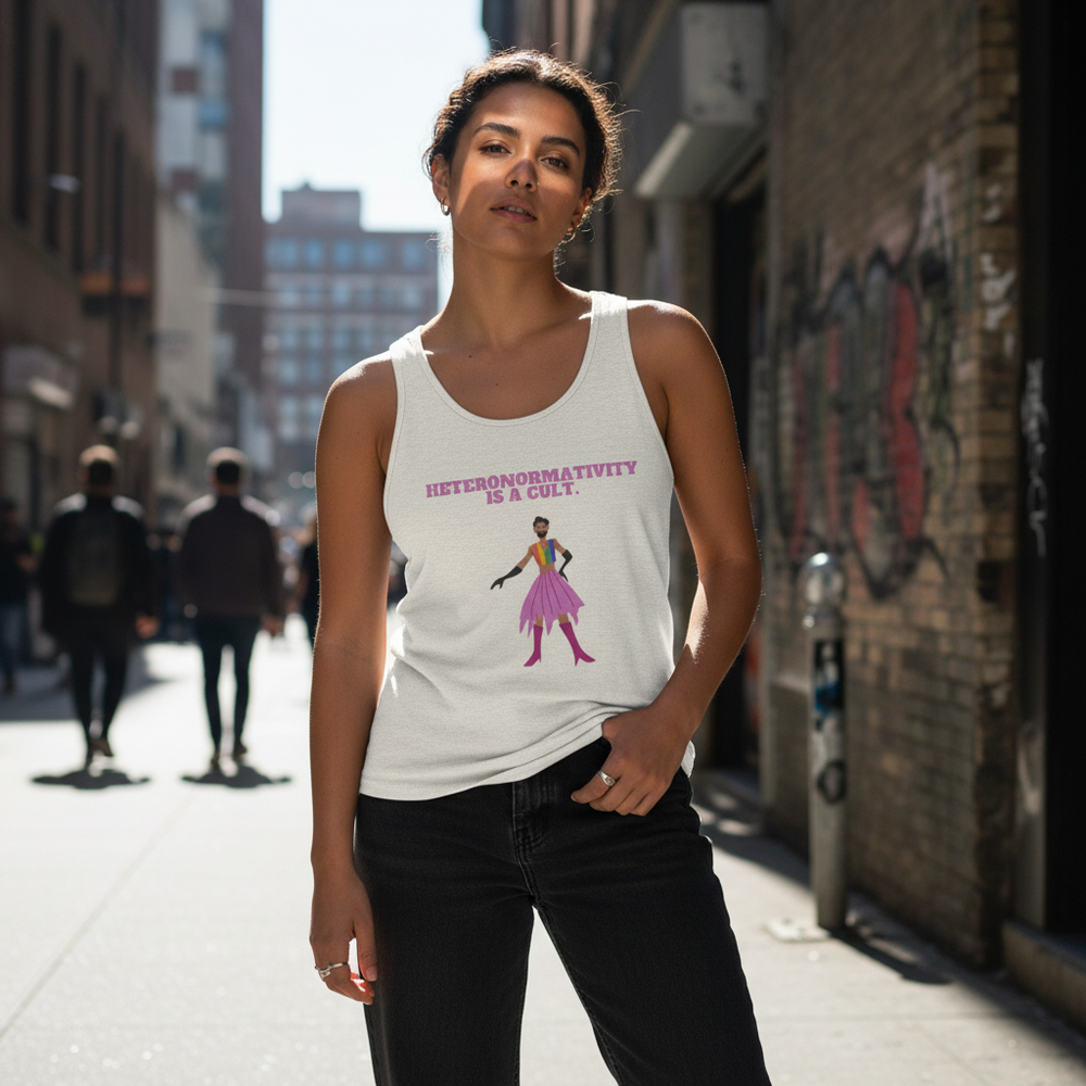 Unisex tank top with “HETERONORMATIVITY IS A CULT” slogan and pink dress graphic, worn by a woman in a sunlit alley.