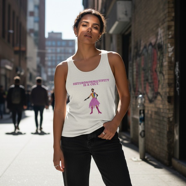 Unisex tank top with “HETERONORMATIVITY IS A CULT” slogan and pink dress graphic, worn by a woman in a sunlit alley.