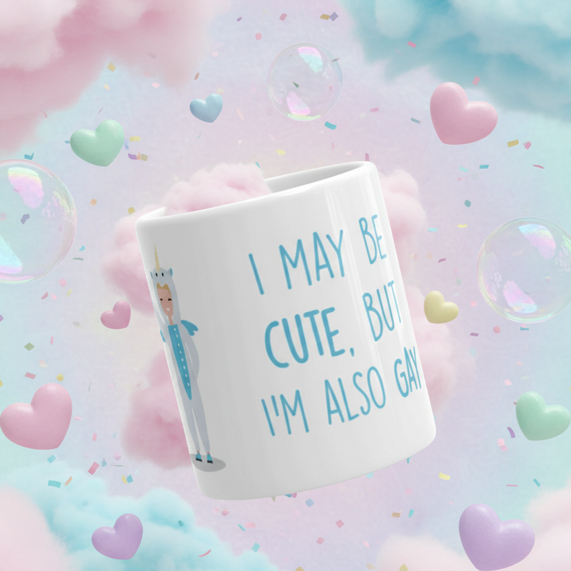 Cute But Gay Mug featuring a cartoon in a unicorn onesie with text I MAY BE CUTE, BUT I’M ALSO GAY. Perfect for proudly expressing LGBTQIA+ identity. Dishwasher and microwave safe, celebrating queer joy.
