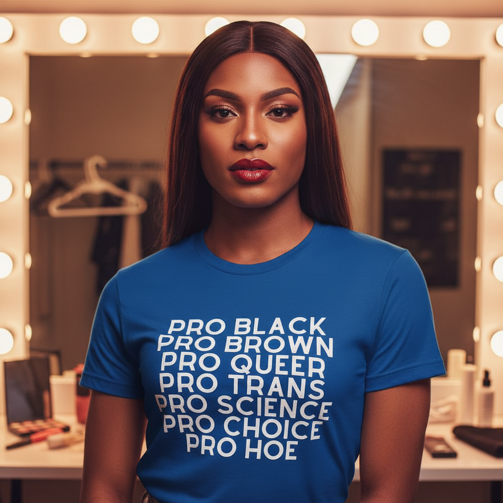 Model wearing a blue T-shirt printed with “PRO BLACK PRO BROWN PRO QUEER PRO TRANS PRO SCIENCE PRO CHOICE PRO HOE”
