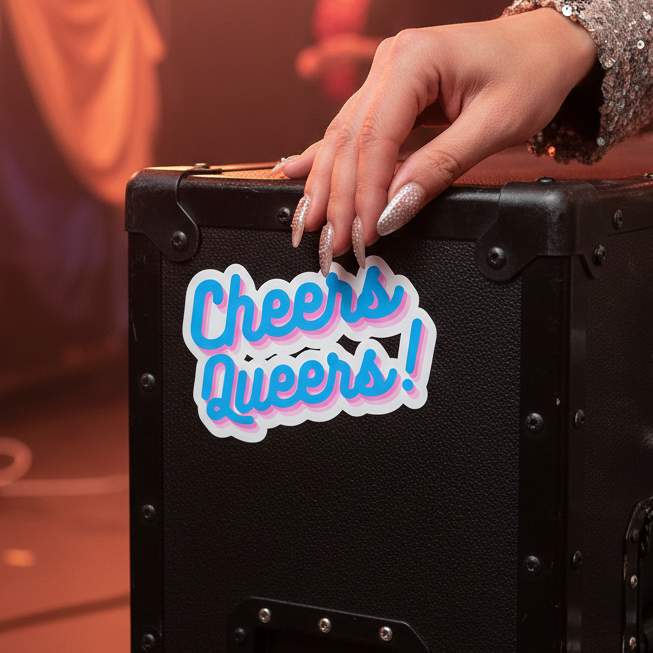 Black case with a vibrant "Cheers Queers!" sticker in bold, playful colors, held by a manicured hand at a pride celebration.
