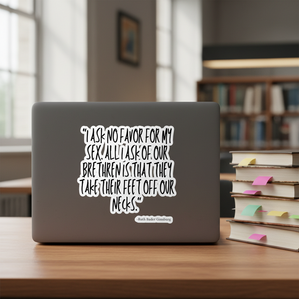 I Ask No Favor For My Sex" bubble-free sticker on a laptop, wood table, stacks of books; Ruth Bader Ginsburg quote visible.