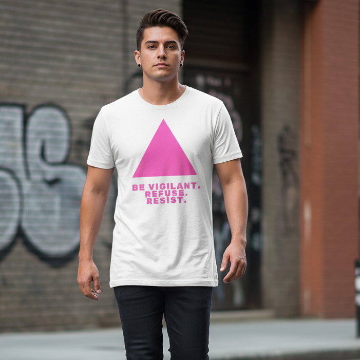 White unisex T-shirt with bold pink triangle and “Be Vigilant. Refuse. Resist.” slogan, worn by a queer person in the city.