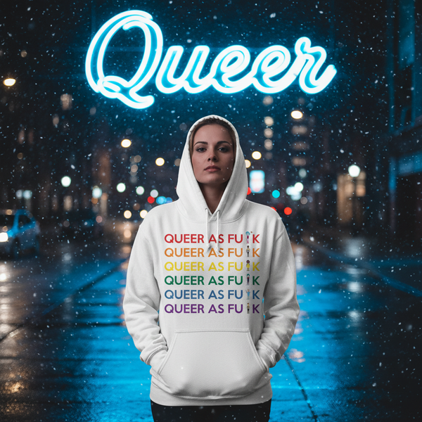 White unisex hoodie with rainbow “QUEER AS FU*K” lettering, worn in a snowy city street